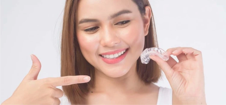 Smiling adult with Invisalign clear aligners