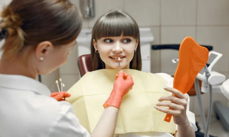 Close-up photo of a person smiling, showcasing white porcelain veneers on their teeth.